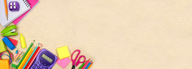 School supplies corner border. Overhead view on a brown paper banner background. Copy space. Back...