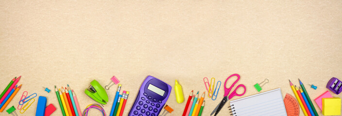 School supplies bottom border. Top view on a brown paper banner background. Copy space. Back to...