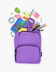 Purple backpack full of spilling school supplies. Top down on a white background. Back to school...