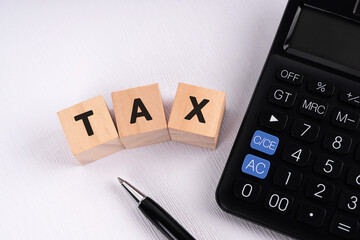 Calculator and tax text on wood blocks