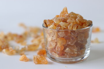 Gond Katira or Gum arabic crystals, also known as edible gum or gond, in a clear glass container