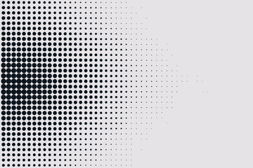 Black dots arranged in a pattern that fades from left to right on a white background surface