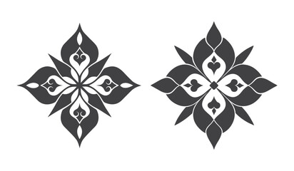 Two symmetrical ornate floral elements with intricate patterns in a dark silhouette