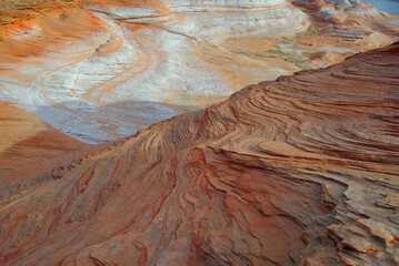 Sandstone Rock Strata Patterns - The setting sun hi-lights sandstone layering on the shores of Lake Powell a reservoir on the Colorado River in Utah and Arizona, United States

