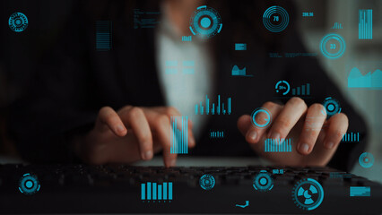 A business professional diligently types on a keyboard in a modern workspace, with graphical elements of data visualization surrounding them, showcasing technology and analytics. Xenic