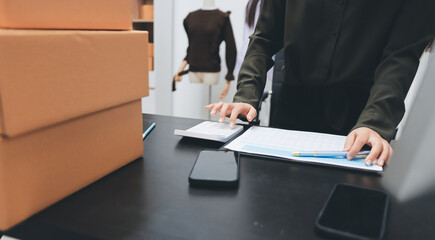 Portrait of Starting small businesses SME owners, two Asian woman check online orders Selling products working with boxs freelance work at home office, sme business online small medium enterprise