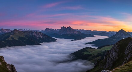 Obraz premium Majestic Mountain Peaks Above Sea of Clouds at Sunrise