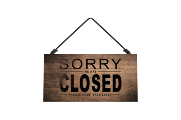 A closed sign posted on glass door of store. Concept of shop service business closed on holidays.