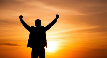 Fototapeta premium Silhouette of a victorious person with arms raised in celebration against a sunset. A concept of success, freedom, achievement, and inspiration.