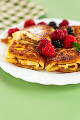 Gourmet breakfast with sweet pancakes and berries