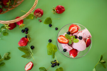 Summer dessert with berries on a green background