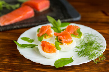 Cold festive appetizer of eggs with fish slices