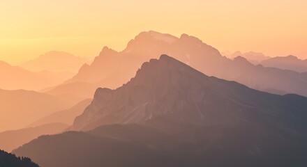Obraz premium Misty Mountain Range at Sunset with Golden Light