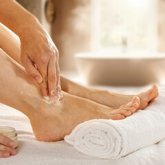Foot massage, self-care and skin nourishment, applying moisturizing cream, home self-care, skincare...