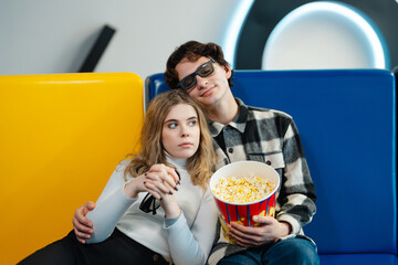 Couple enjoying a movie together in a modern cinema setting