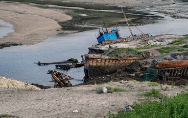 old abandoned sunken ship in the water at the ship cemetery
