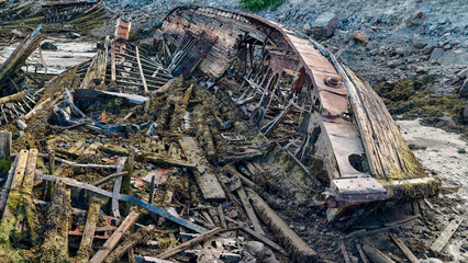 old abandoned sunken ship in the water at the ship cemetery