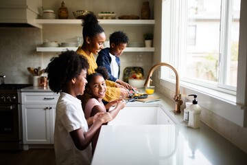 Happy african american family cooking together in kitchen home lifestyle concept