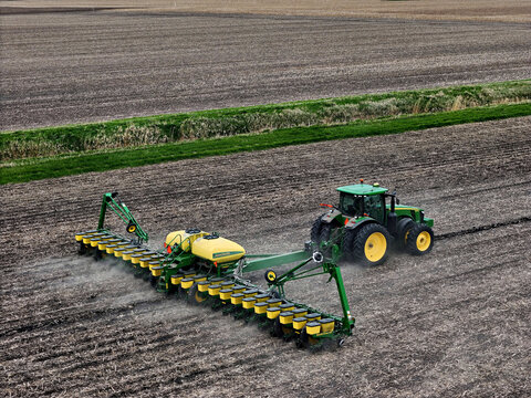 Ottawa, Illinois - USA -  April 30, 2025 John Deere 8335R tractor planting a field with a John Deere 1770NT MaxEmerge XP 24 row Planter