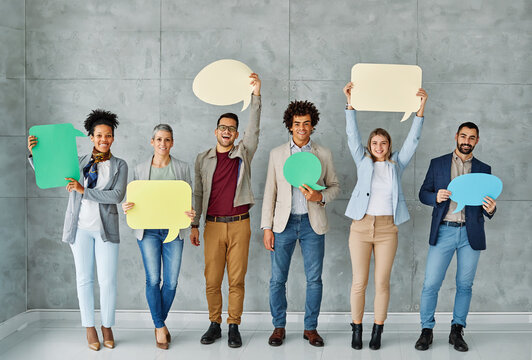 Portrait of a group of young business people in office. Speech bubble, team and comment by business people holding sign, news and voice icon feeling excited on social media. Group, opinion and poll by - Powered by Adobe