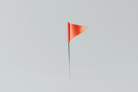 An orange triangular flag stands tall against a plain backdrop, exuding a sense of playful minimalism and modern simplicity in its clean design.