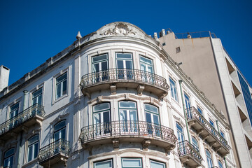 Elegant apartment building with balconies against a clear blue sky