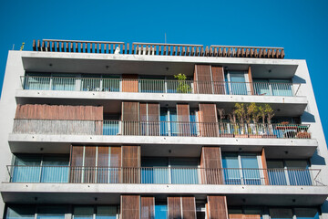 Modern Apartment Building with Balconies and Wooden Shutters