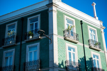 Corner Building in Lisbon with Green Facade and Balconies