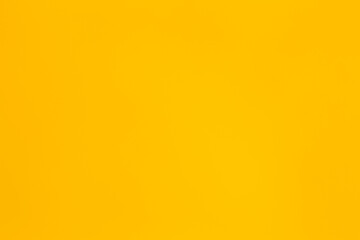 Soft grades of dark full colour yellow backdrop with paper texture
