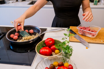 Woman Preparing Healthy Meatballs and Mashed Potatoes in Modern Kitchen with Fresh Vegetables