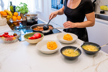 Woman Cooking Meatballs and Mashed Vegetables in Modern Kitchen with Fresh Ingredients