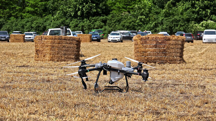 Agricultural drone on field during farm demonstration. Grounded agriculture drone in a dry field...