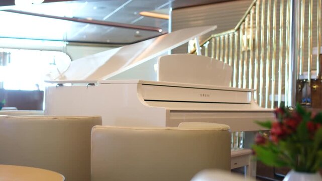 Brilliant white piano with the lid open for better sound. The camera moves around. High quality 4k footage