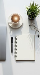 Clean White Desk with Notebook, Coffee Cup, and Laptop in Natural Light

