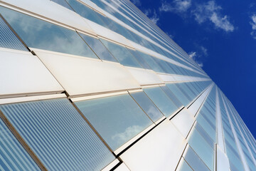 View of the windows of the skyscraper on the blue sky background