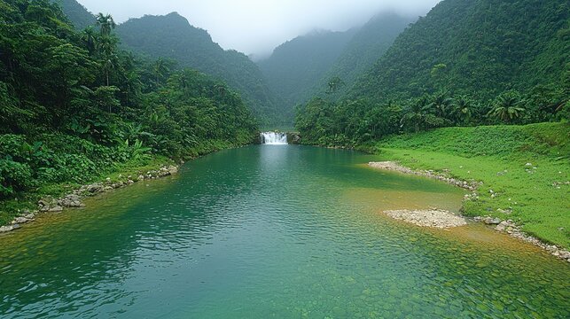 Green river flows through a lush, misty mountain pass