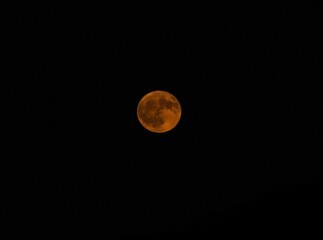 Bright Orange Full Moon in Night Sky