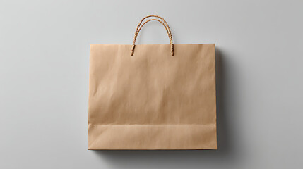 Top Down View of a Light Brown Paper Shopping Bag with Twisted Paper Handles Against a Gray Background