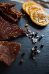 Dehydrated meat in pieces with spices and orange