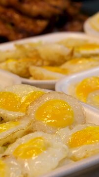 Quail Egg Skewers being cooked at Shilin Night Market, Taipei, Taiwan. Taiwanese street food. Low angle, parallax movement, slow motion, HD.