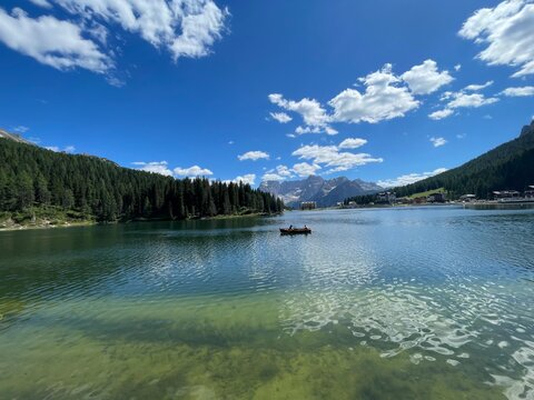 Rowboat on Lake Misurina, Italy &ndash; Serene Summer Day with Clear Blue Sky and Reflections of the Dolomites in Calm Water, Surrounded by Forest and Mountains in the Heart of the Italian Alps