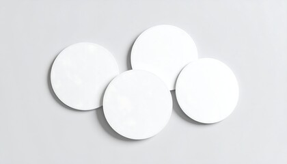Four blank white coasters