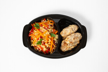 Steamed chicken rolls with bulgur and vegetables on a ceramic plate on white background