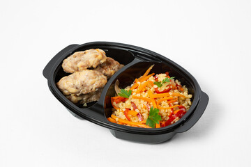 Steamed chicken rolls with bulgur and vegetables on a ceramic plate on white background