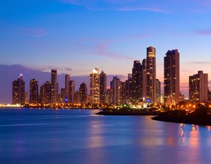 Fototapeta premium City skyline at twilight, modern buildings reflect on water