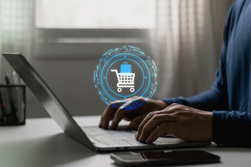 Customer typing on laptop with shopping cart icon, online shopping, ecommerce transaction, digital retail. Technology business, payment, consumerism, purchase across mobile and computer platforms.