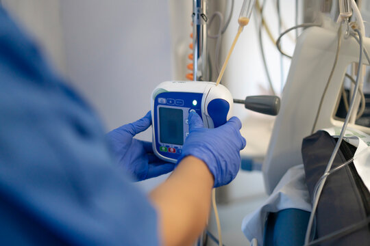 Nurse using infusion pump in hospital setting to deliver medication