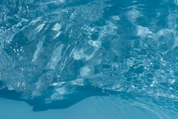 Blue water with ripples on the surface. Defocus blurred transparent blue colored clear calm water...