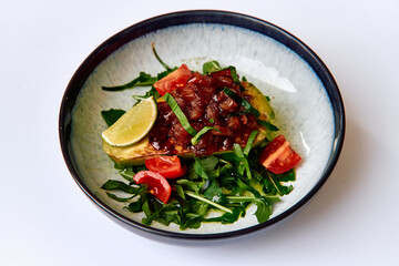 Deliciously Plated Avocado Dish Garnished with Fresh Salsa, Lime, and Tomato on a Bed of Arugula for a Vibrant and Healthy Meal Option