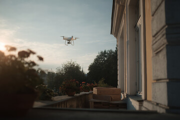 drone delivering pizza gracefully lands on balcony in sunny courtyard creating moment of excitement